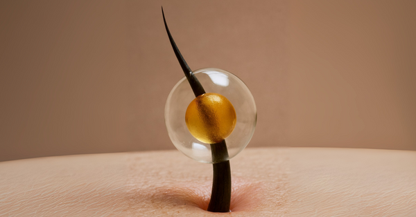 Close-up of a single hair strand emerging from scalp with a golden oil droplet, symbolizing the strengthening power of phytokeratin for healthy hair.